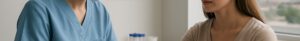 Nurse drawing blood for ferritin test in modern Mansfield clinic with educational posters.